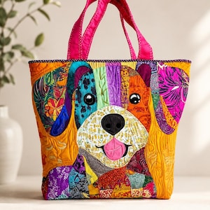 May include: A quilted tote bag featuring a colorful patchwork dog face design. The bag has bright pink fabric handles and is constructed from various patterned fabric scraps in shades of orange, purple, blue, and yellow, with a black nose and pink tongue.