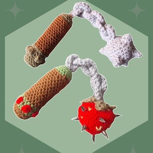 May include: Image of two crochet flails, one with a brown handle and a white star-shaped head, the other with a brown handle and a red spiky head. The text "Mini Flail" and "Crochet Pattern" are displayed.