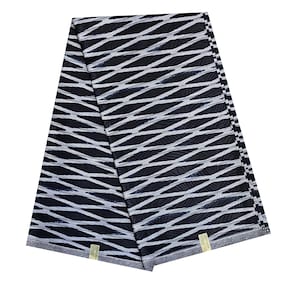 May include: A folded piece of fabric featuring a dark navy blue background with a repeating pattern of white, wavy, horizontal lines that create a net-like effect. The textile has a smooth, slightly reflective surface and a finished edge border.