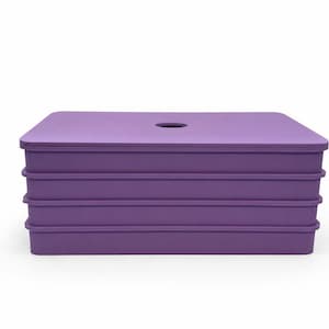 May include: A stackable, rectangular storage container in a vibrant purple hue. The container has a flat top with a circular opening and three lower sections. The design is simple and modern, suitable for various storage needs.