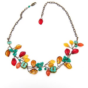 May include: A copper wire necklace with orange, red, and turquoise glass beads shaped like leaves.