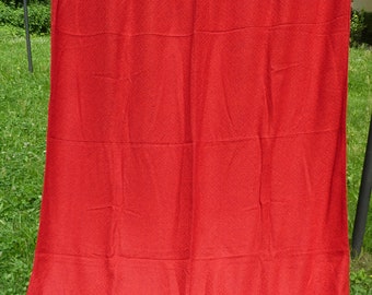 May include: A solid red fabric curtain hanging on a clothesline.