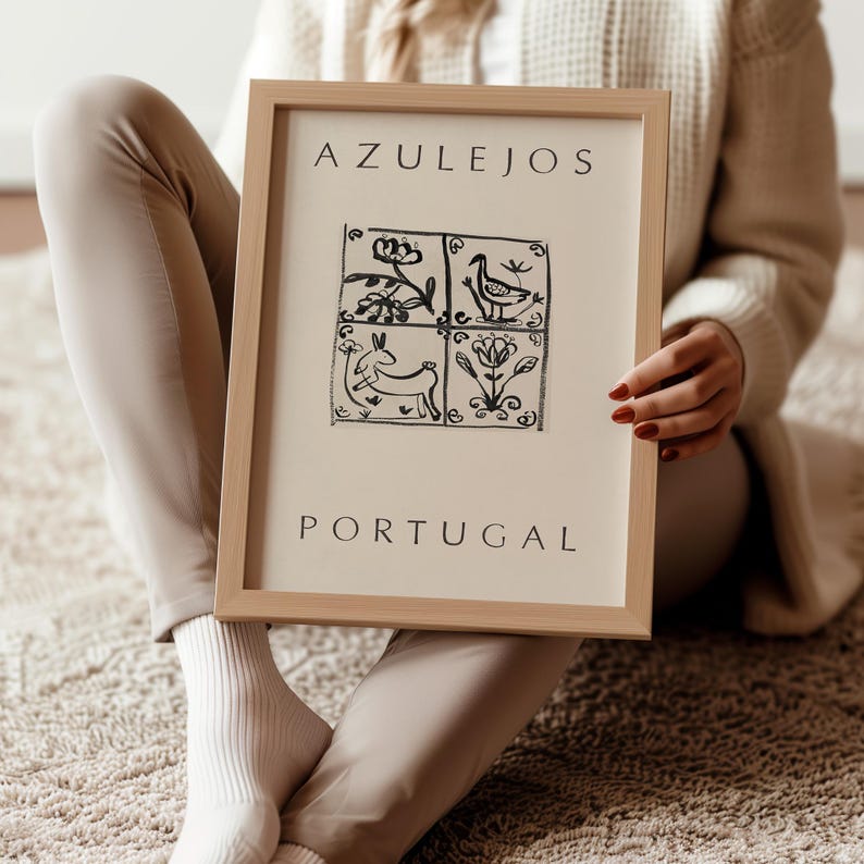 May include: A framed print with the text "AZULEJOS PORTUGAL" and a black and white illustration of four tiles with stylized designs of a bird, flowers, and a rabbit.
