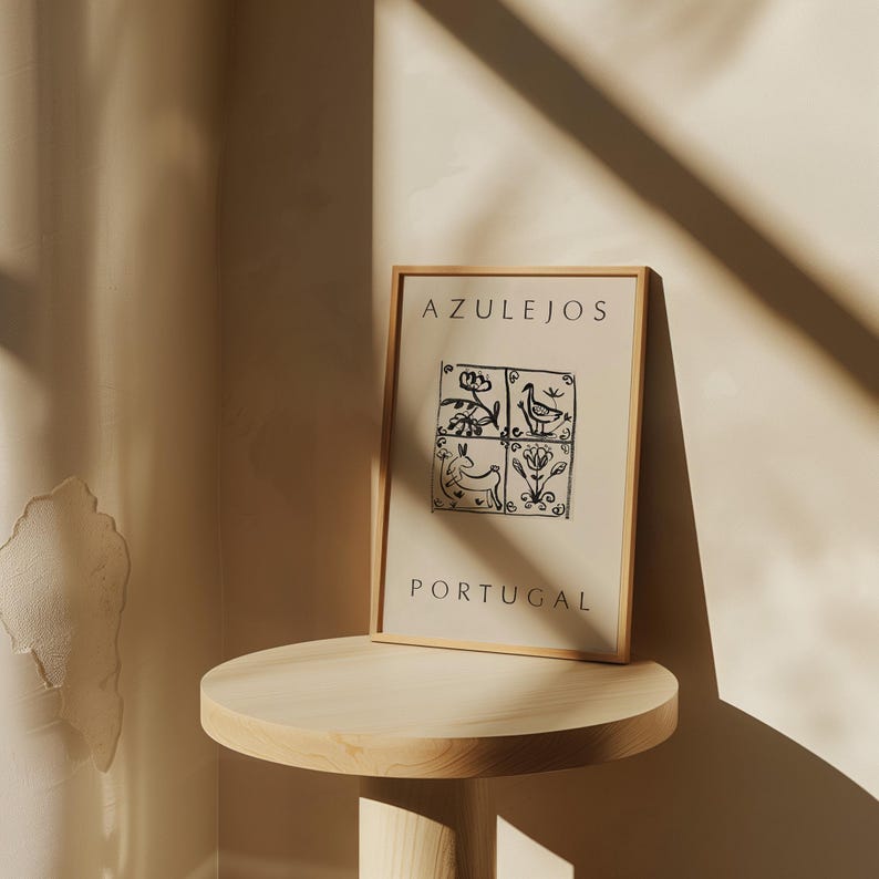 May include: A framed print with a black and white illustration of four traditional Portuguese tiles. The tiles feature a bird, a flower, a rabbit, and another flower. The print has the text "AZULEJOS PORTUGAL" at the top and bottom.