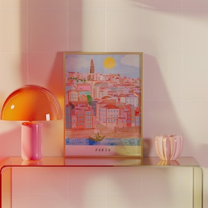 May include: A framed illustration of a cityscape with a bright yellow sun in the sky. The city is painted in shades of pink, blue, and green. The text "PORTO" is printed at the bottom of the illustration.