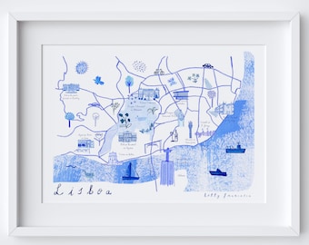 May include: A blue and white illustrated map of Lisbon, Portugal, with various landmarks and points of interest labeled. The map is framed in a white frame. The artist's signature, "Holly Francesca", is in the bottom right corner.