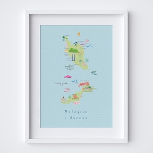 May include: A framed print featuring a colorful map of Malaysia and Borneo. The map is light blue with illustrations of landmarks, palm trees, and boats. The text "Malaysia & Borneo" is written in a handwritten style at the bottom.