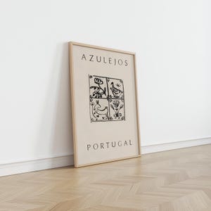 May include: A framed print with a beige background and black illustrations of stylized flowers, a bird, and a rabbit. The text "AZULEJOS PORTUGAL" is printed below the illustrations.
