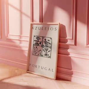 May include: A framed print with the word "AZULEJOS" and "PORTUGAL" in black text on a white background. The print features a black and white illustration of four traditional Portuguese tiles with floral and animal designs.