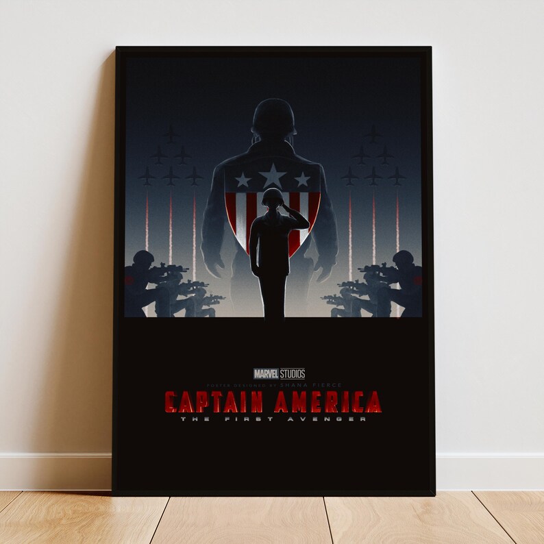 May include: A framed poster featuring a silhouette of Captain America saluting, with a large shield design in the background. The poster has a dark color scheme with the text "CAPTAIN AMERICA THE FIRST AVENGER" at the bottom.