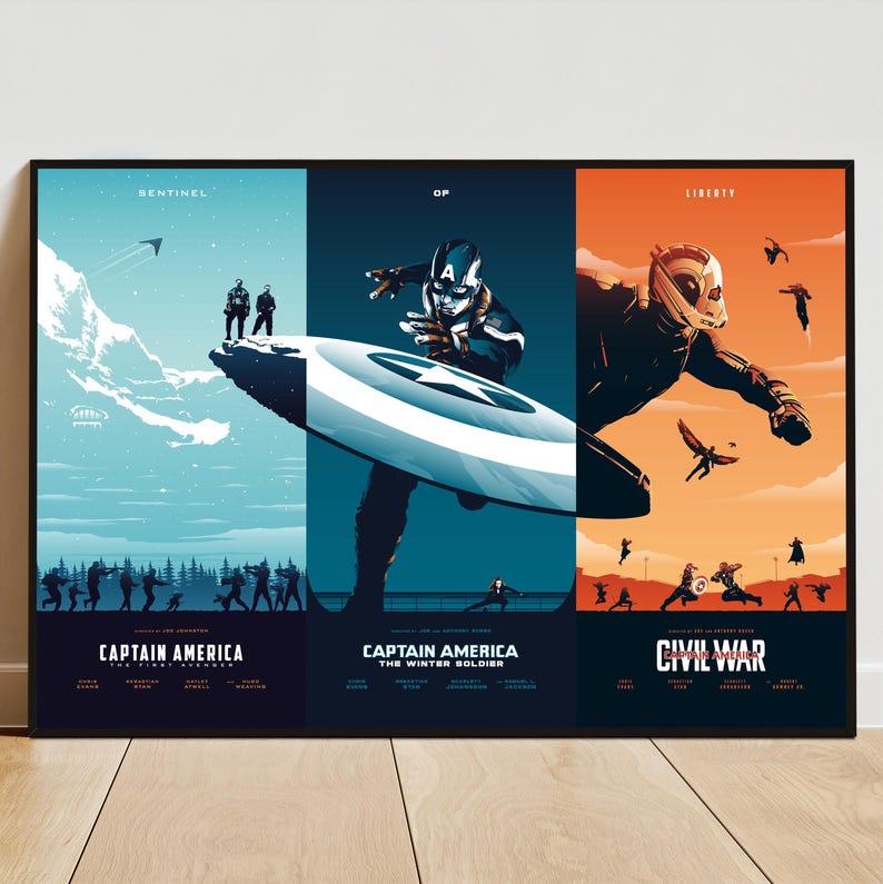May include: A framed poster featuring three panels with Captain America themes. The left panel shows a snowy landscape with figures, the center panel features Captain America with his shield, and the right panel depicts a character in flight. Text includes "Sentinel", "Of", and "Liberty".