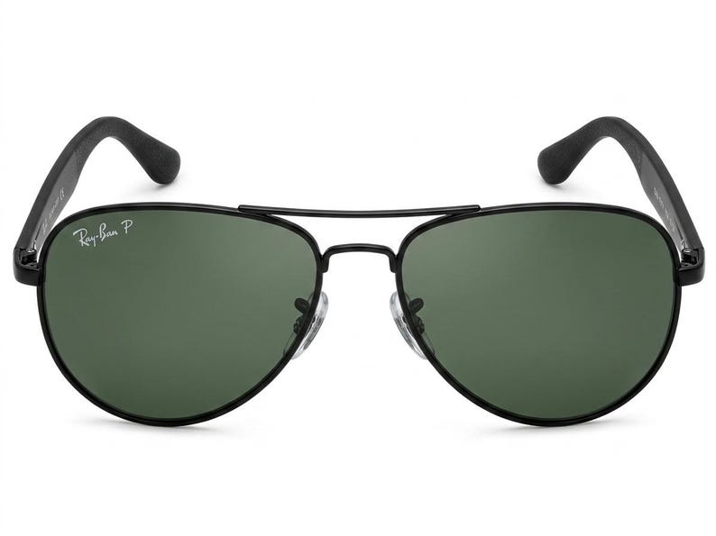 May include: Aviator sunglasses featuring a thin black metal frame and dark green lenses. The left lens displays the white Ray-Ban P logo. The design includes a double bridge, adjustable nose pads, and black temple arms with curved tips.