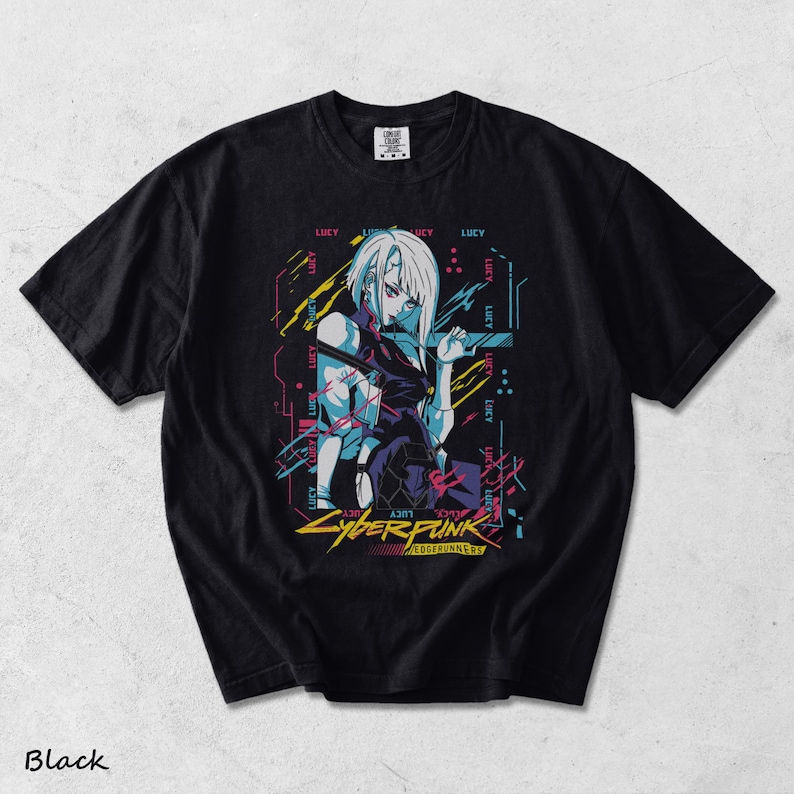 May include: A black short-sleeved t-shirt featuring a graphic print of a character with white hair. The design includes the text "LUCY" repeated in the background, along with "CYBERPUNK EDGERUNNERS" in yellow text at the bottom, accented by blue, pink, and yellow lines.