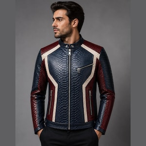 May include: A multi-colored jacket featuring a textured snakeskin pattern in navy blue, deep red, and cream. The garment has a stand-up collar with a snap button, a full-length silver metal zipper, and three zippered pockets on the front chest and sides.