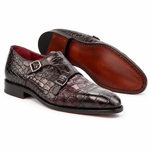Men’s dark chocolate brown double monk strap shoes showing stitched leather outsole, stacked heel and croc embossed leather upper.