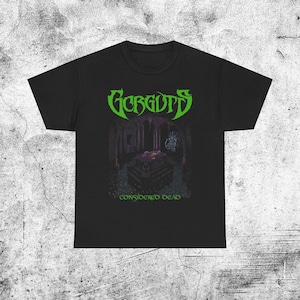 Puede incluir: Camiseta negra con el nombre de la banda "Gorguts" en verde, sobre una ilustración oscura de una cripta. El texto "CONSIDERED DEAD" está debajo. La camiseta es de material suave.