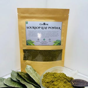 May include: A brown paper bag of soursop leaf powder, a glass bowl of powder, and green leaves. The bag has text that reads "SOURSOP LEAF POWDER" and "EXPIRED DATE: 2027.01.20". The powder is a vibrant green colour.