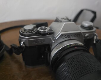 Cámara de película Canon AE-1 de 35 mm con 2 objetivos Vivitar. En funcionamiento.