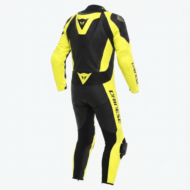 May include: A black and yellow motorcycle racing suit with the Dainese logo. The suit features yellow panels on the arms, legs, and sides, and black panels on the back, shoulders, and inner legs. Protective padding is visible on the knees and elbows.