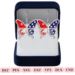 May include: A pair of butterfly-shaped earrings featuring a red, white, and blue patriotic design with stars and stripes, suspended from silver-toned hooks. The earrings are displayed inside a dark blue velvet-lined jewelry box with text DXT PES XXX EXP VP3 HUS CND.
