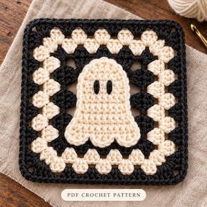 May include: A square crochet granny square featuring a central cream-coloured ghost motif with two black oval eyes. The square is bordered by alternating rounds of black and cream yarn. The text PDF CROCHET PATTERN is printed at the bottom.