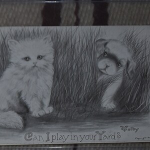 May include: A black and white drawing of a cat and a puppy peeking out from behind tall grass. The text "Can I play in your yard?" is written below the image.