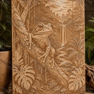 May include: A rectangular wooden wall plaque featuring a detailed laser-engraved relief of a frog perched on a tree branch. The scene includes a tropical jungle background with dense foliage, palm leaves, a flowing waterfall, and birds in the sky.
