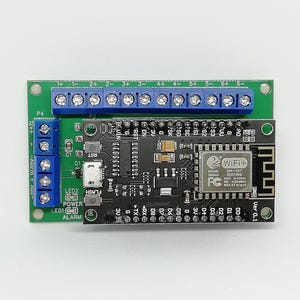 May include: A black and green circuit board with blue and black connectors. The board has various components, including a WiFi module, labeled pins, and the text "WiFi+".
