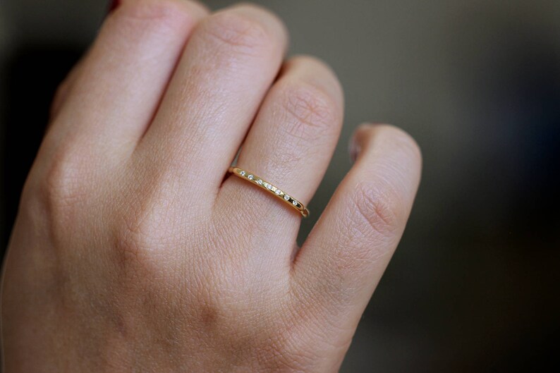 thin gold ring with tiny diamond