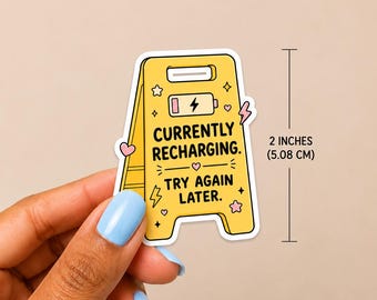 May include: A yellow caution sign sticker featuring a battery icon and the text "CURRENTLY RECHARGING. TRY AGAIN LATER." decorated with small pink hearts, stars, and lightning bolts. The sticker measures 2 inches in height as indicated by a line.