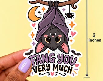 May include: A die-cut sticker featuring a cartoon bat hanging from a branch with the text FANG YOU VERY MUCH. The bat has large eyes, pink ears, and purple wings. The design includes a crescent moon, a spider, and stars. It measures 2 inches tall.