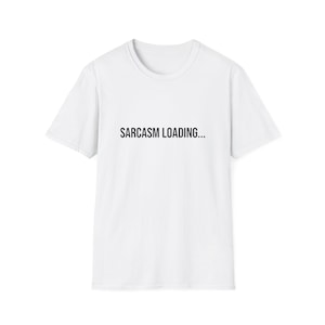 May include: A white short-sleeved t-shirt featuring the text "SARCASM LOADING..." printed in black capital letters across the center of the chest. The garment has a classic crew neckline and a straight hemline, providing a clean and simple look.