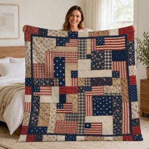 May include: A patchwork quilt featuring a variety of fabric patterns in red, white, and blue. The design incorporates rectangular and square blocks with floral prints, plaid, stripes, and star motifs, arranged in a geometric, multi-directional layout.