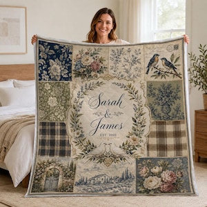 May include: A quilted throw blanket featuring a patchwork design with floral patterns, plaid squares, and a central wreath motif. The center displays the text Sarah & James EST. 2026 surrounded by two white doves. The color palette includes navy, sage, and cream.