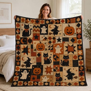 May include: A rectangular patchwork quilt featuring Halloween-themed motifs including black cats with orange bows, smiling jack-o'-lanterns, white ghosts, and witches on broomsticks. The design incorporates stars, moons, and plaid patterns.
