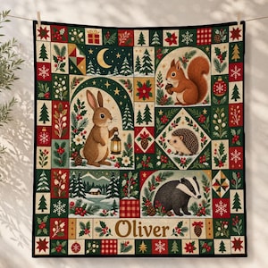 May include: A rectangular quilt featuring a patchwork design with illustrations of a rabbit holding a lantern, a squirrel, a hedgehog, and a badger. The border includes pine trees, holly, snowflakes, and ornaments. The name Oliver is printed at the bottom.