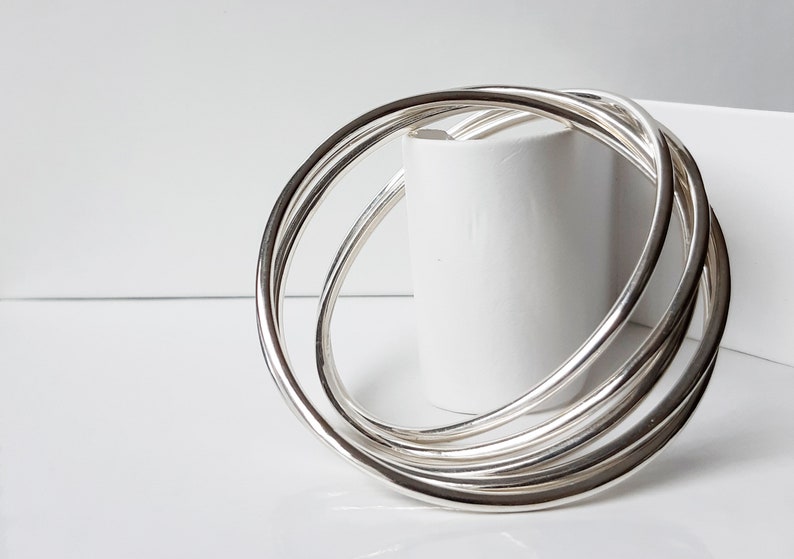 Sterling silver bracelet with five inter-connected bangles