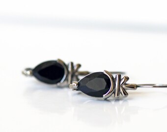 Vintage marquis cut cubic zirconia (7 x 9 mm) crystals set in hematite forms with lever-back hooks.  Never worn!