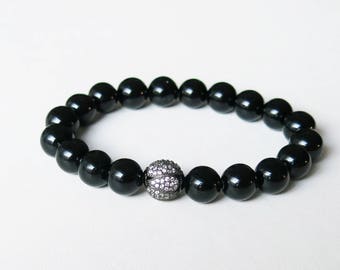 Black onyx bracelet with blackened sterling silver Swarovski crystal focal bead strung on sturdy elastic