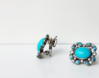 Hematite adjustable clip-on earrings with natural turquoise focal beads and turquoise and clear Swarovski crystals.