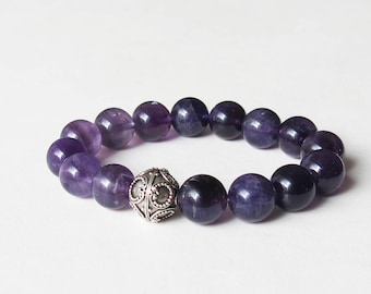 Amethyst crystal bracelet with sterling silver bali focal bead strung onto sturdy elastic