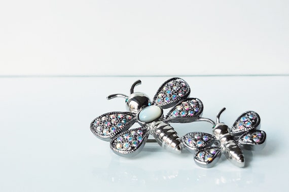Vintage rhodium plated moth brooch with aurora borealis Swarovski crystals and white cat's eye oval cabochon