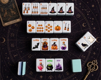 May include: A set of white rectangular Mahjong tiles featuring Halloween-themed illustrations including brooms, pumpkins, witch hats, ghosts, bats, potions, and cauldrons. Some tiles display numbers, the words Flower, Joker, Red, Greene, and Soap, and colourful graphics.