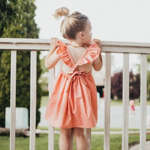 Coral Pin Dot Ruffle Dress. Peach Pink Dress Dress. Summer Dress. Kids Dresses. Toddler Dresses. Tank Dresses. Ruffle Dress. Polka Dot Dress