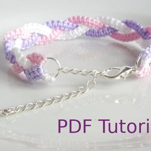 A bracelet that has a 3 braid effect. Each braid is made using square knots and each braid is in a separate colour - white, lilac and pink. With a close up of the metal chain and clasp closure. With PDF Tutorial written on the image.