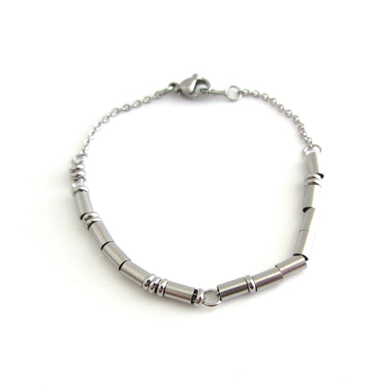 A stainless steel I love you Morse Code bracelet (thin round and cylinder beads spell out the message) with a fine cable chain and lobster claw clasp.