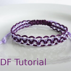 Purple and lilac macrame alternating square knot bracelet. With a purple slider closure and lilac pull cords. With PDF Tutorial written on the image.