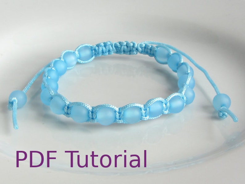 Light blue beaded macrame square knot bracelet with slider closure. With PDF Tutorial written on the image.