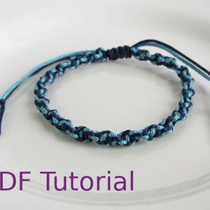 Light blue and navy blue macrame half square knot bracelet. With a navy blue slider closure. With PDF Tutorial written on the image.