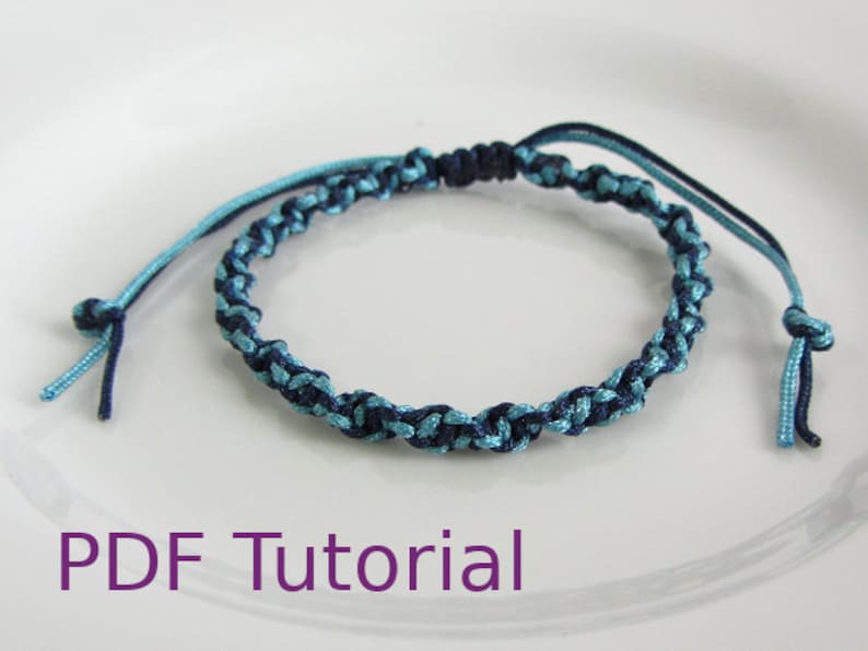 Light blue and navy blue macrame half square knot bracelet. With a navy blue slider closure. With PDF Tutorial written on the image.